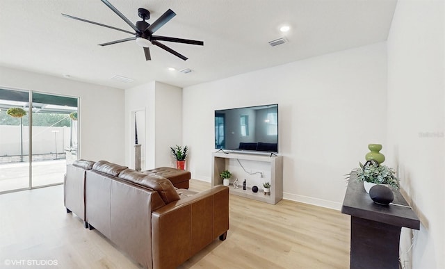 living room with ceiling fan and light wood-type flooring