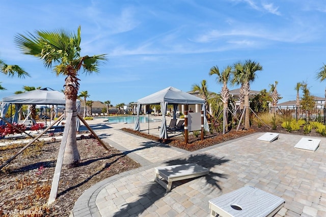 view of swimming pool featuring a gazebo and a patio