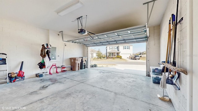 garage featuring a garage door opener and electric panel