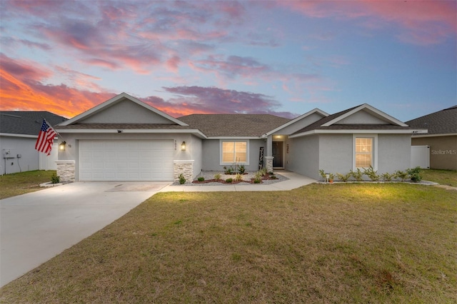 ranch-style home featuring a garage and a yard