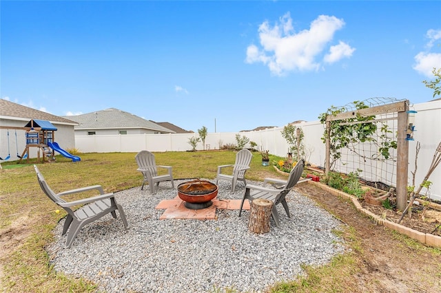 view of patio / terrace featuring a playground and an outdoor fire pit