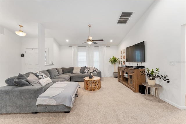 carpeted living room featuring ceiling fan and vaulted ceiling