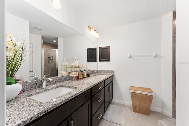 bathroom featuring walk in shower, vanity, and tile patterned flooring