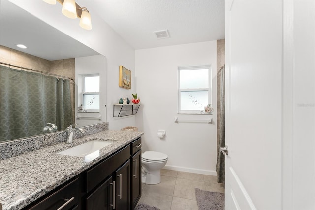 bathroom with curtained shower, toilet, tile patterned floors, and vanity