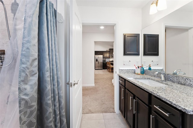 bathroom with tile patterned floors and vanity