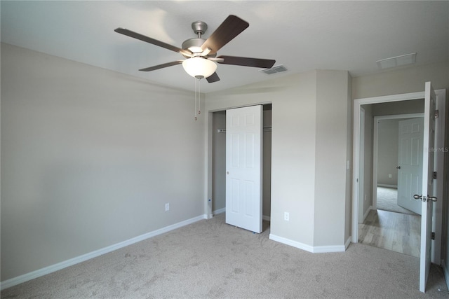 unfurnished bedroom with a closet, ceiling fan, and light colored carpet