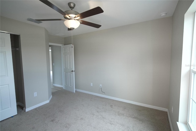 unfurnished bedroom with a closet, ceiling fan, and light colored carpet