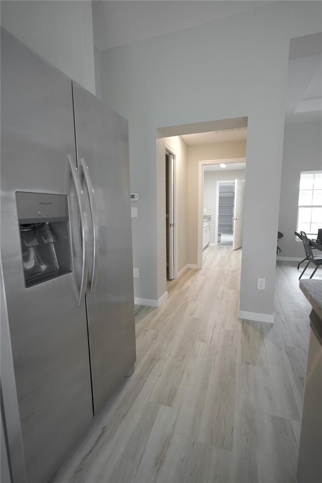 kitchen featuring light hardwood / wood-style flooring and stainless steel refrigerator with ice dispenser