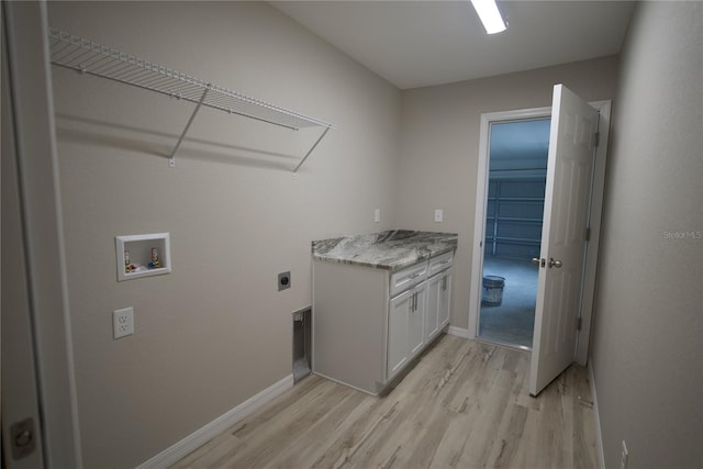 laundry area with cabinets, washer hookup, electric dryer hookup, and light wood-type flooring