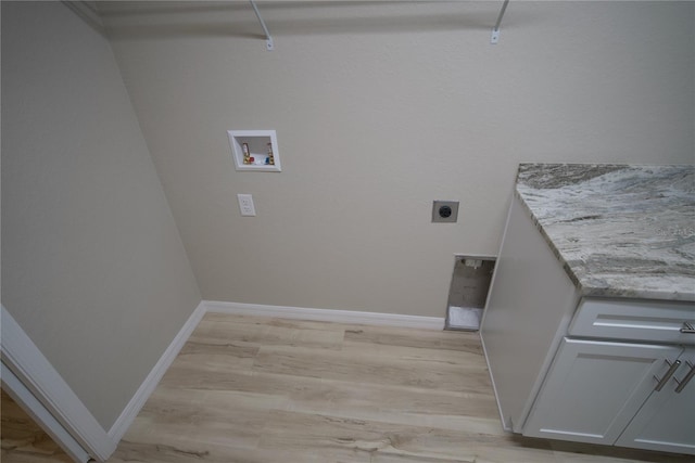 washroom featuring hookup for an electric dryer, light hardwood / wood-style flooring, and hookup for a washing machine