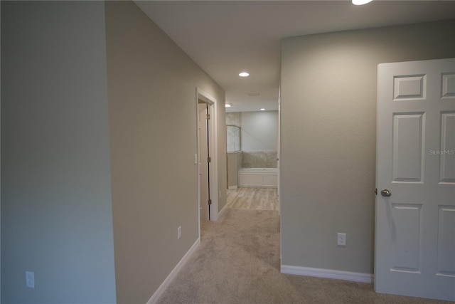 hallway with light colored carpet