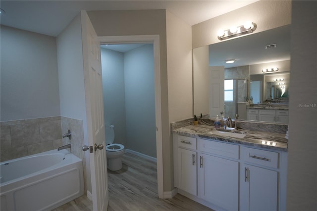 full bathroom with hardwood / wood-style flooring, toilet, vanity, and plus walk in shower