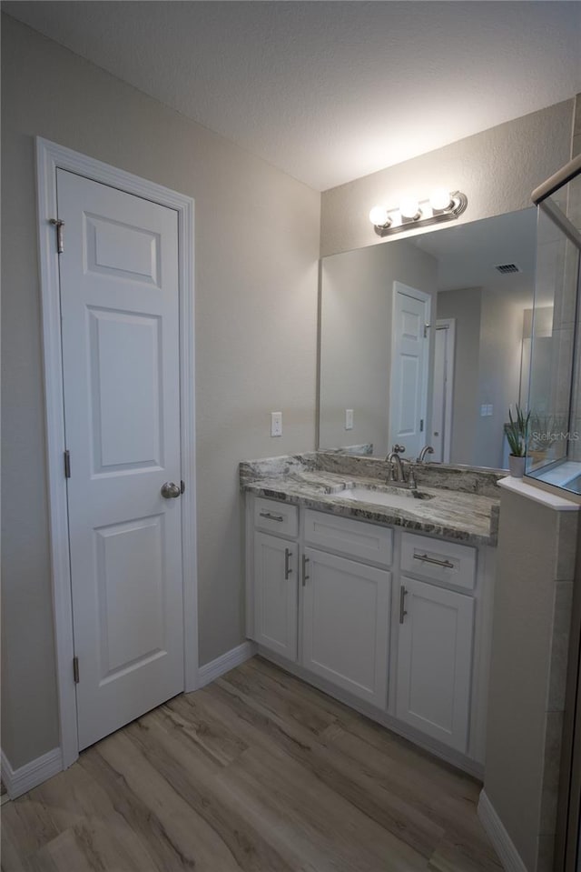 bathroom with hardwood / wood-style flooring and vanity