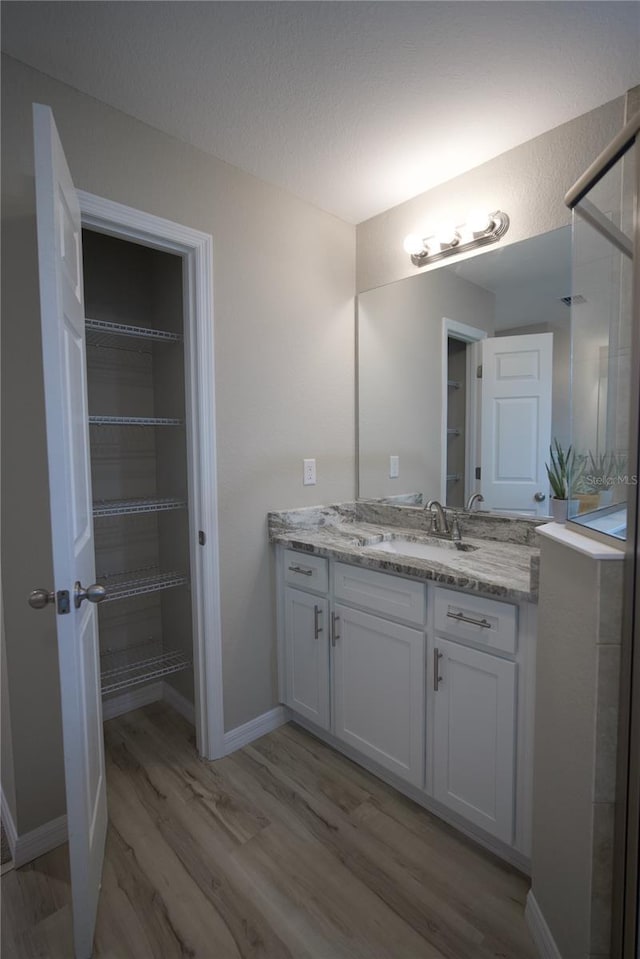 bathroom with vanity and hardwood / wood-style flooring