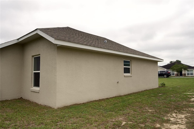 view of side of property with a yard