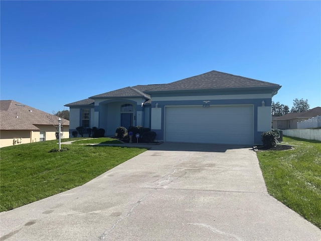 single story home with a garage and a front lawn