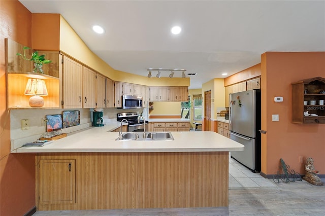 kitchen featuring light brown cabinetry, appliances with stainless steel finishes, light tile patterned floors, sink, and kitchen peninsula