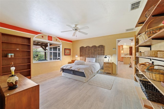 bedroom with light hardwood / wood-style floors and ceiling fan