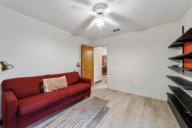 living room with light wood-type flooring and ceiling fan