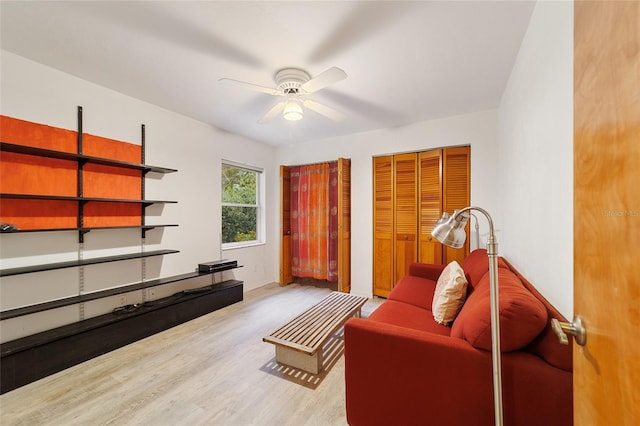 living area with light hardwood / wood-style flooring and ceiling fan