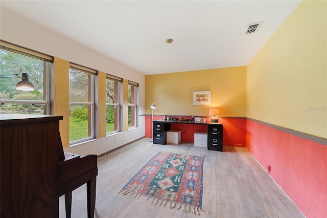 office with light wood-type flooring