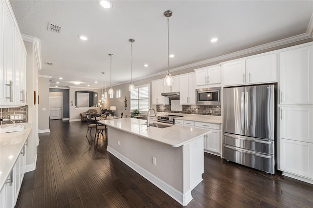 kitchen featuring sink, white cabinetry, pendant lighting, stainless steel appliances, and light stone countertops