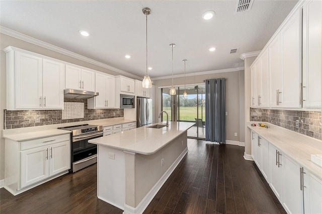 kitchen featuring an island with sink, appliances with stainless steel finishes, sink, and white cabinets