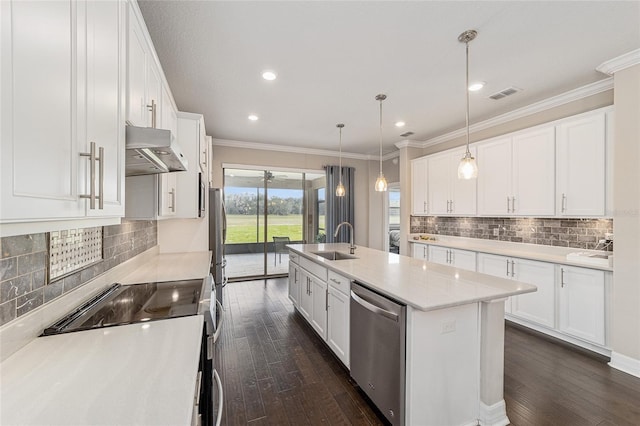 kitchen with stainless steel appliances, pendant lighting, and white cabinets