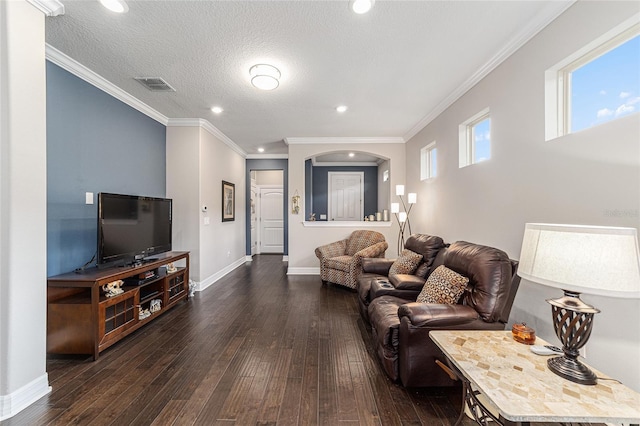 living room with crown molding, dark wood-type flooring, and a textured ceiling