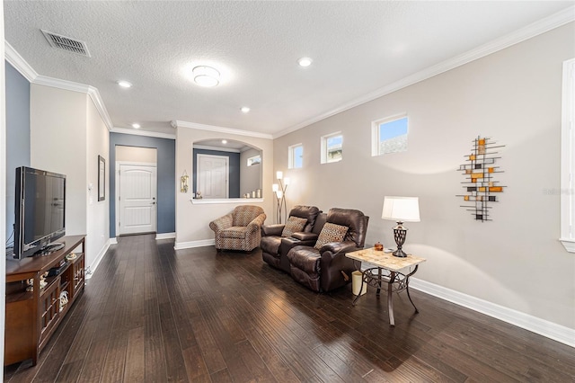 living room with ornamental molding, dark hardwood / wood-style floors, and a textured ceiling