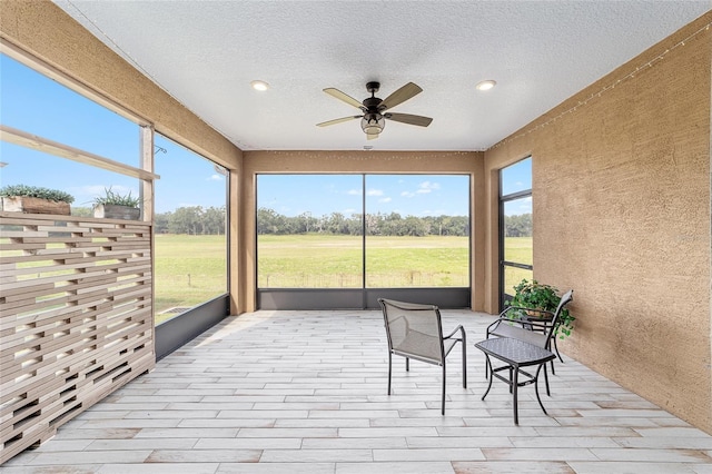 sunroom / solarium with ceiling fan