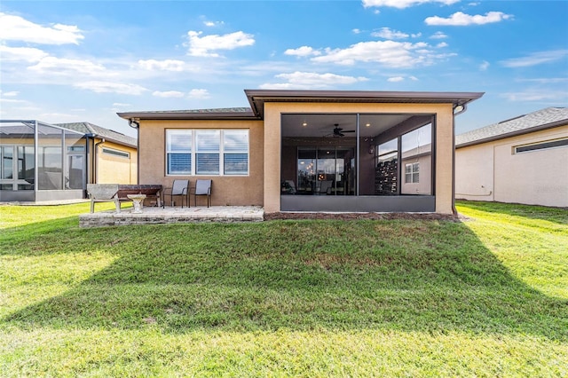 back of house with ceiling fan, a patio, a sunroom, and a lawn