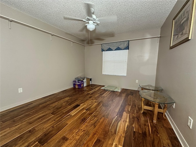 unfurnished room featuring ceiling fan, hardwood / wood-style floors, and a textured ceiling