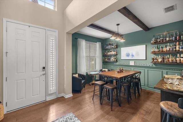 entryway featuring indoor bar, plenty of natural light, and beam ceiling