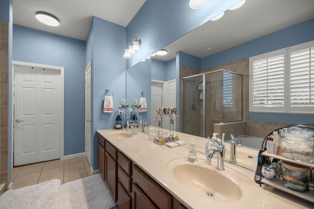 bathroom featuring a shower with shower door, tile patterned floors, and vanity