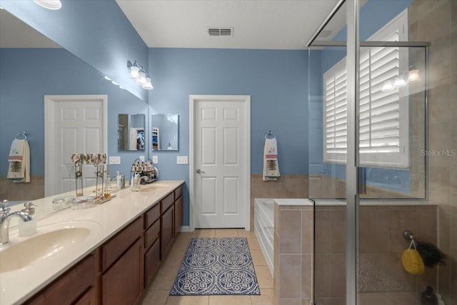 bathroom featuring vanity, independent shower and bath, and tile patterned floors