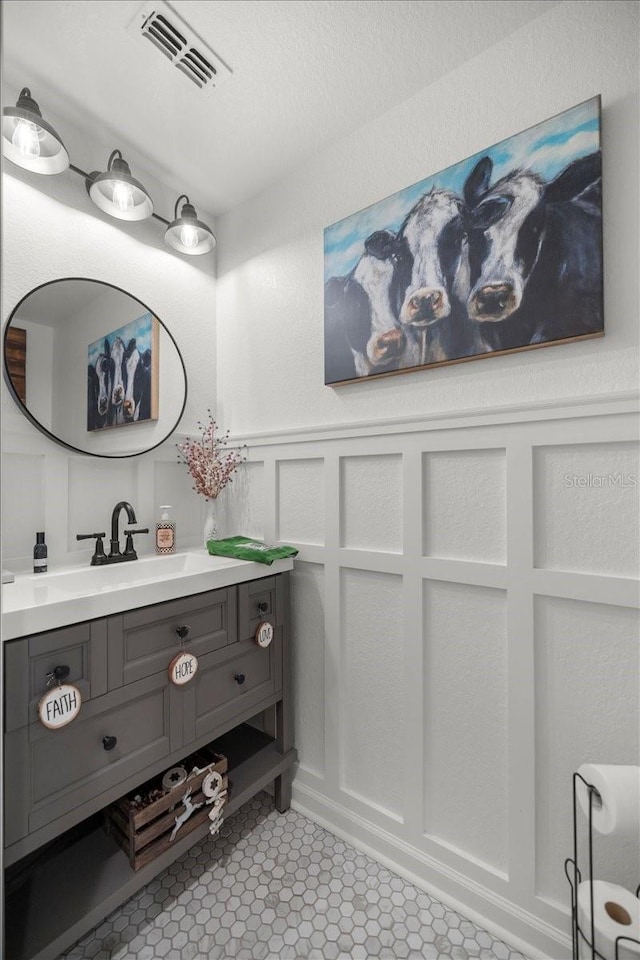 bathroom featuring tile patterned flooring and vanity