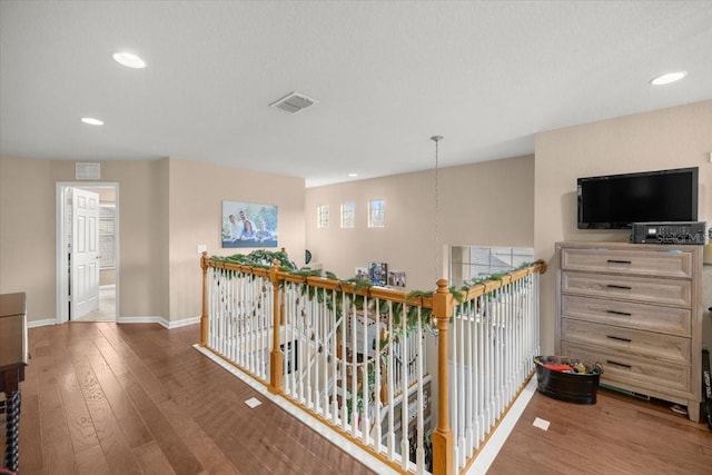 hallway with dark hardwood / wood-style floors