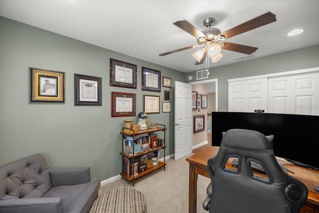 carpeted office space with ceiling fan