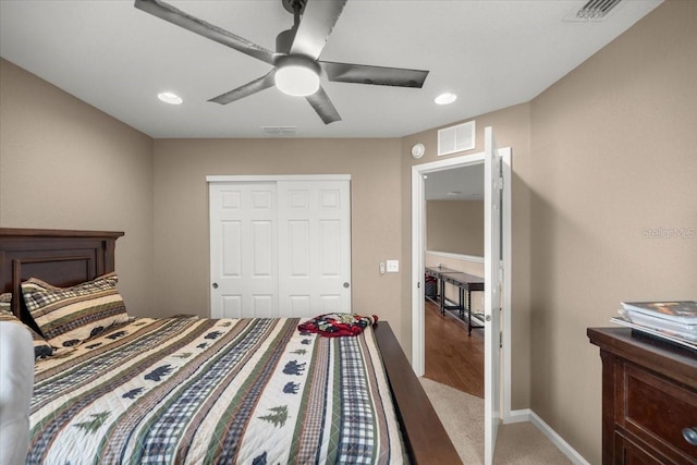 carpeted bedroom with a closet and ceiling fan