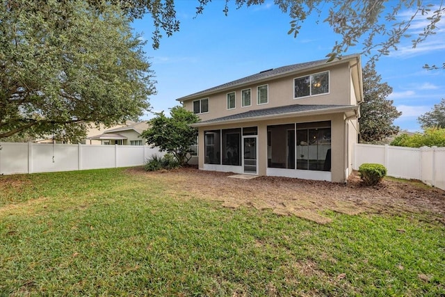 rear view of property with a sunroom and a yard