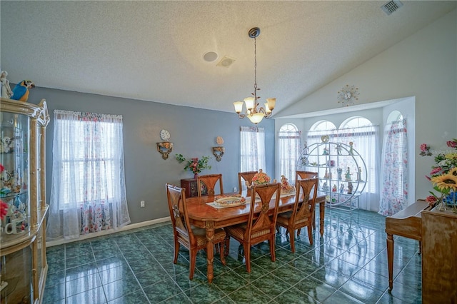 dining area featuring vaulted ceiling, an inviting chandelier, and a textured ceiling