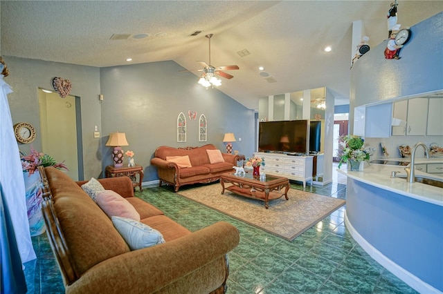 living room featuring sink, a textured ceiling, high vaulted ceiling, and ceiling fan