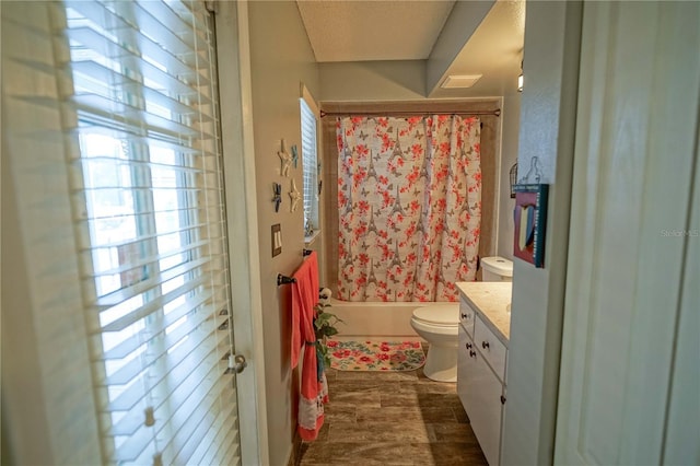 full bathroom with hardwood / wood-style flooring, toilet, vanity, and shower / bath combination with curtain