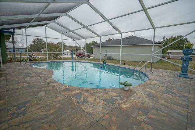 view of swimming pool with a lanai and a patio