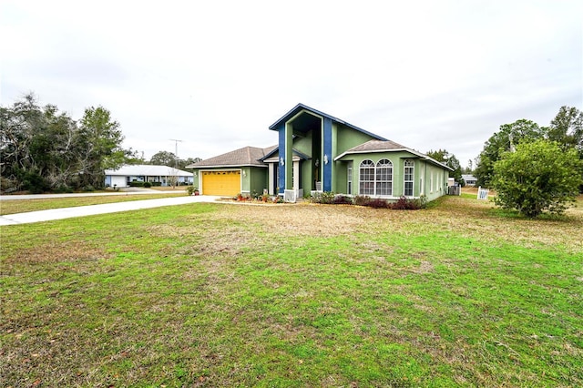 view of front of home with a front yard, driveway, an attached garage, and stucco siding