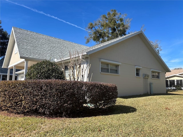 view of property exterior with a lawn