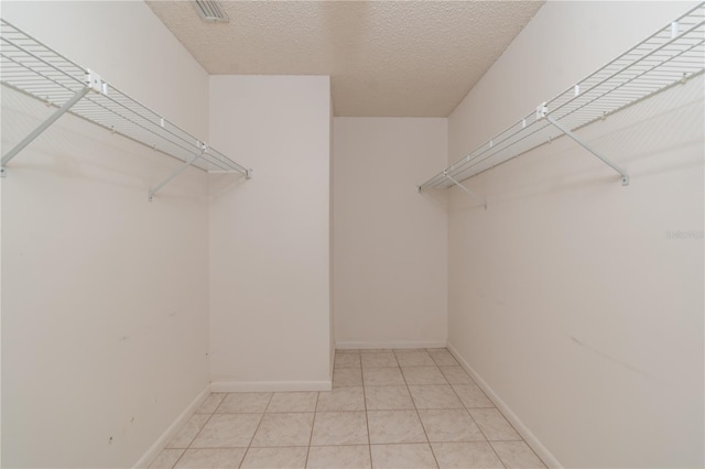 spacious closet with visible vents and light tile patterned floors