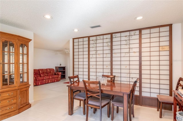 dining area with visible vents, a textured ceiling, and recessed lighting