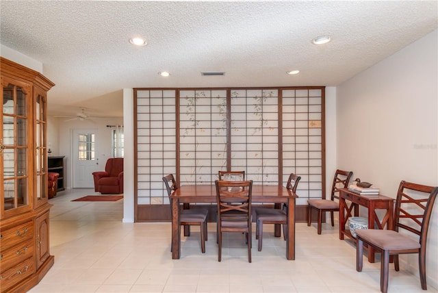 dining space with a textured ceiling, ceiling fan, visible vents, and recessed lighting